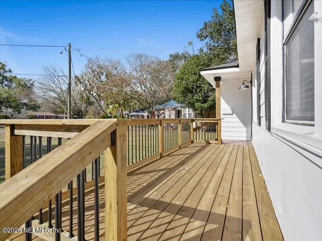 a view of balcony with wooden floor and fence