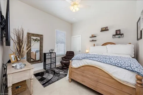 a bedroom with a bed couch and window