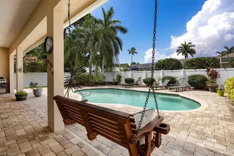 a view of a swimming pool with a lounge chairs