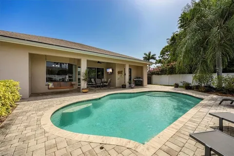 a view of a house with swimming pool and sitting area