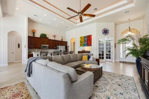 a living room with furniture a window and a ceiling fan