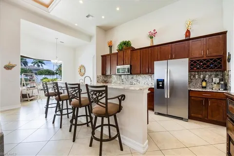 a kitchen with stainless steel appliances granite countertop a refrigerator and a stove top oven