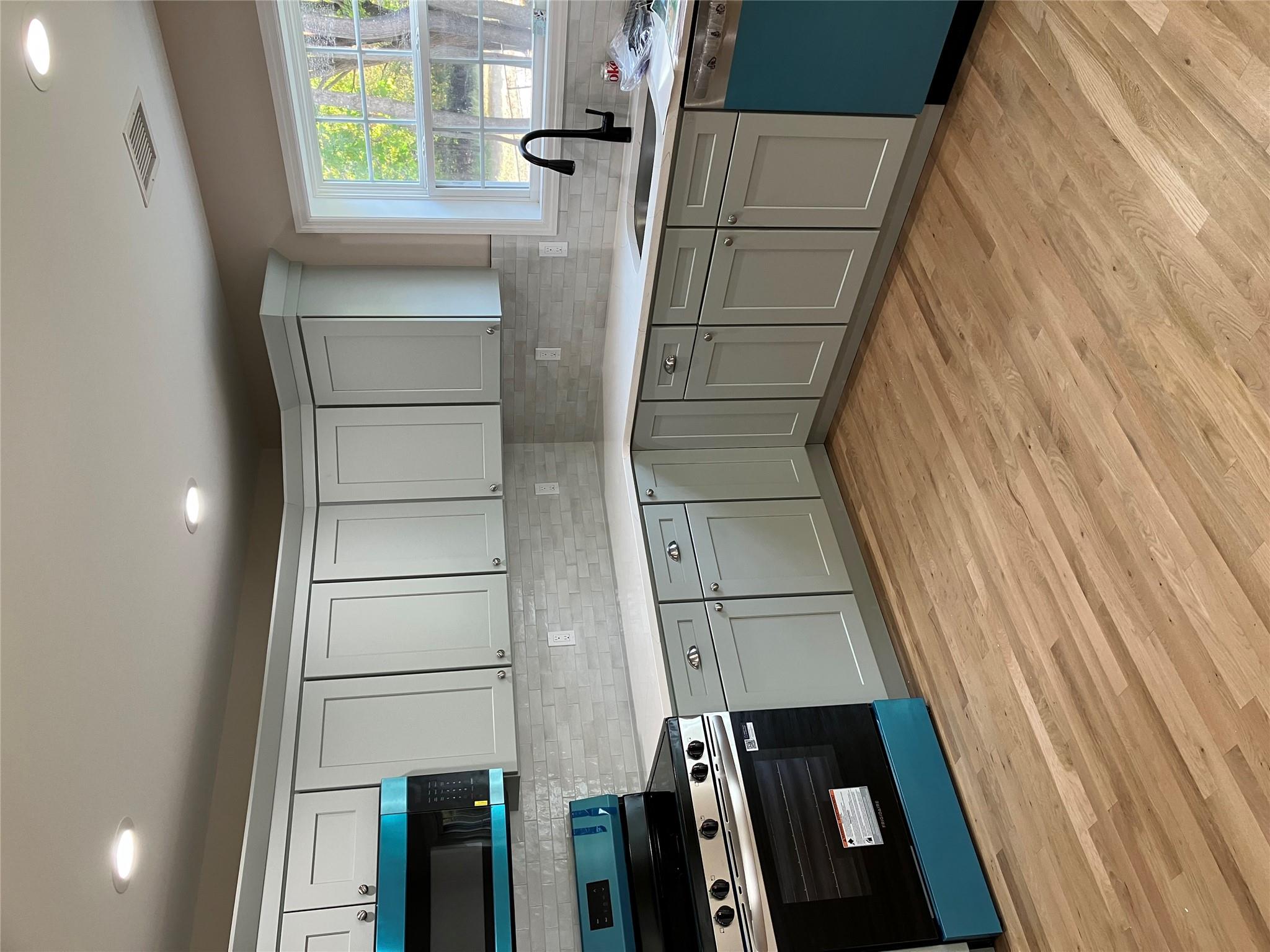 0 Mill Road Coram, NY 11727 - Photo 4 of 28 a kitchen with stainless steel appliances granite countertop a sink and cabinets