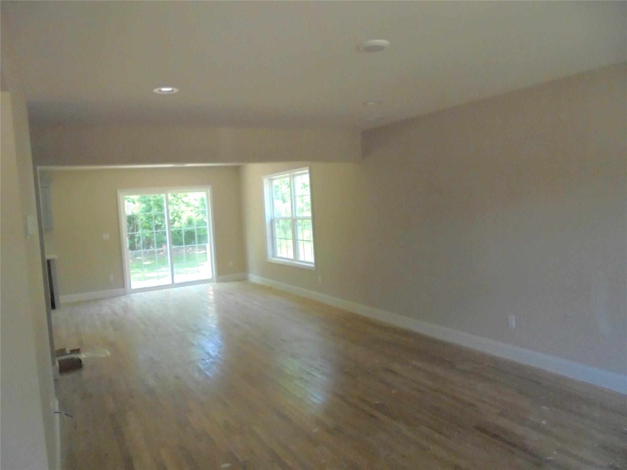 0 Mill Road Coram, NY 11727 - Photo 9 of 28 an empty room with wooden floor and windows