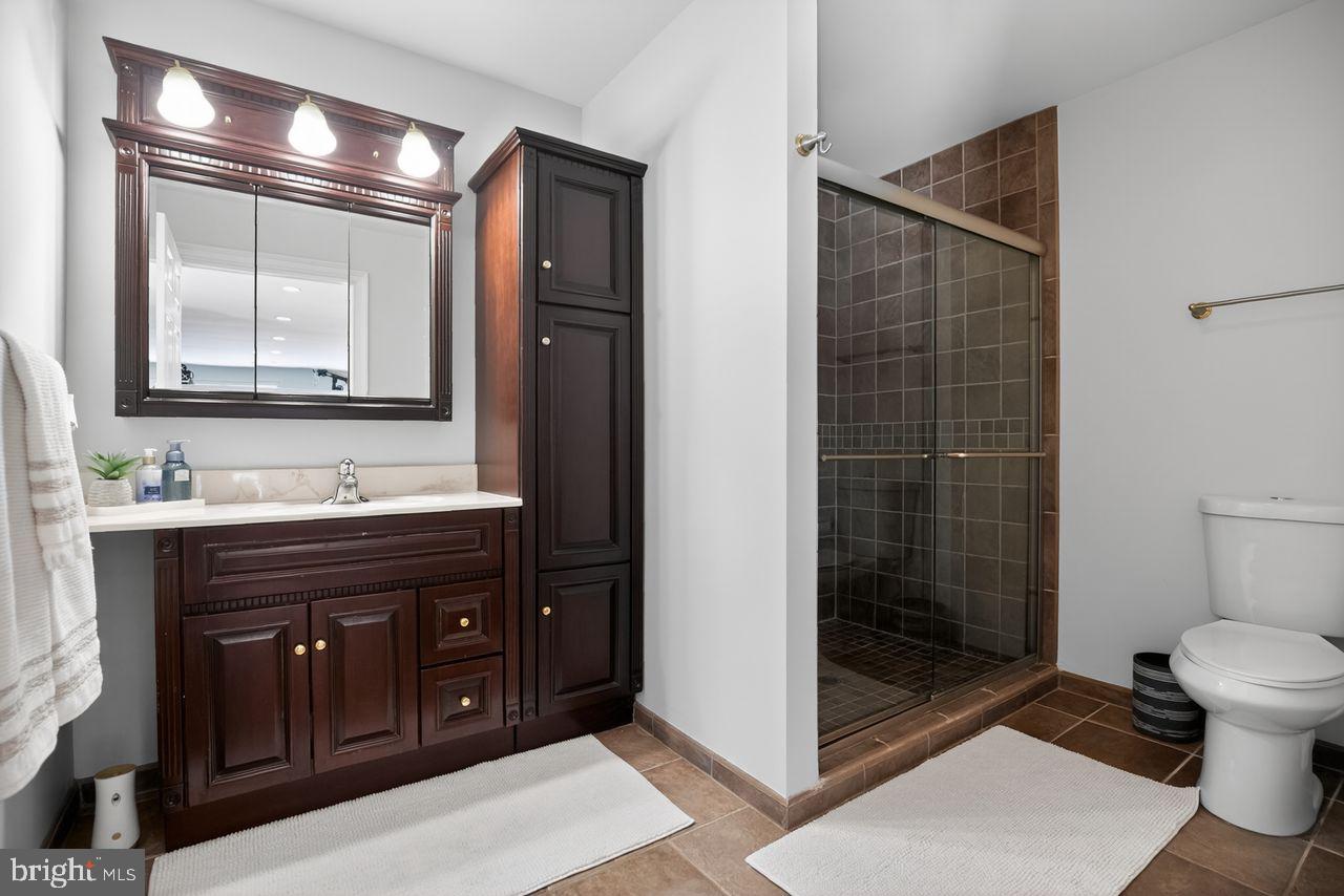 4304 Bridgeboro Road Moorestown, NJ 08057 - Photo 26 of 40 a bathroom with a double vanity sink toilet and shower