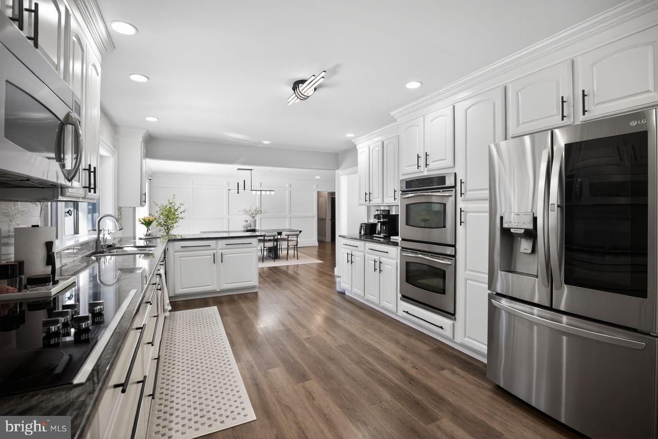 4304 Bridgeboro Road Moorestown, NJ 08057 - Photo 7 of 40 a kitchen with stainless steel appliances a refrigerator a stove top oven and sink