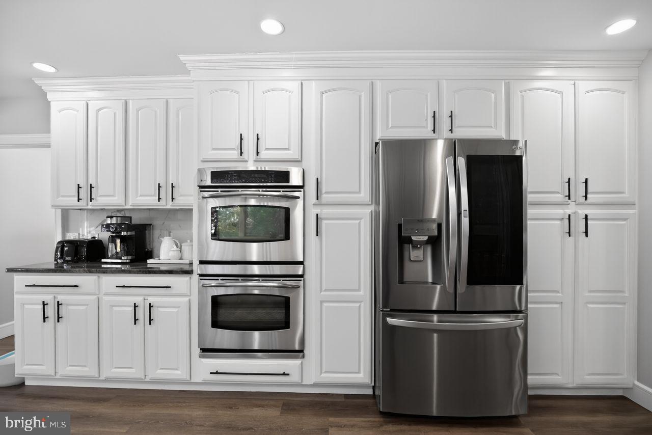 4304 Bridgeboro Road Moorestown, NJ 08057 - Photo 8 of 40 a kitchen with stainless steel appliances granite countertop a refrigerator and a stove top oven