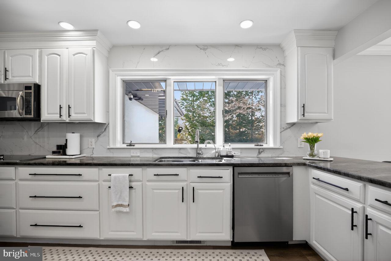 4304 Bridgeboro Road Moorestown, NJ 08057 - Photo 9 of 40 a kitchen with granite countertop white cabinets and white appliances