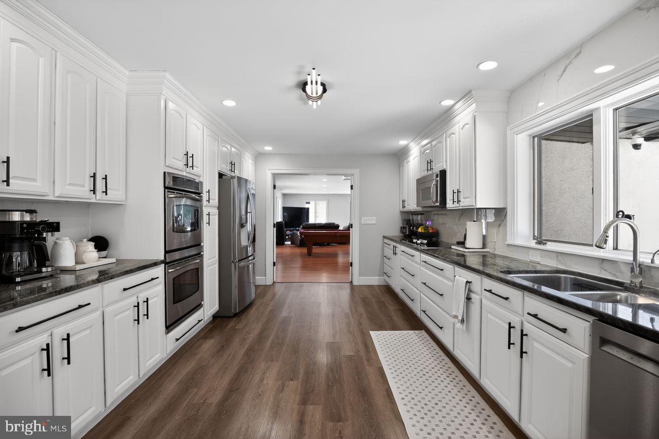 4304 Bridgeboro Road Moorestown, NJ 08057 - Photo 10 of 40 a large kitchen with stainless steel appliances lots of counter space and wooden floor