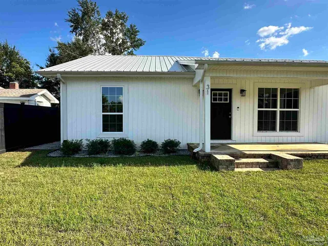 a view of a house with swimming pool and a yard