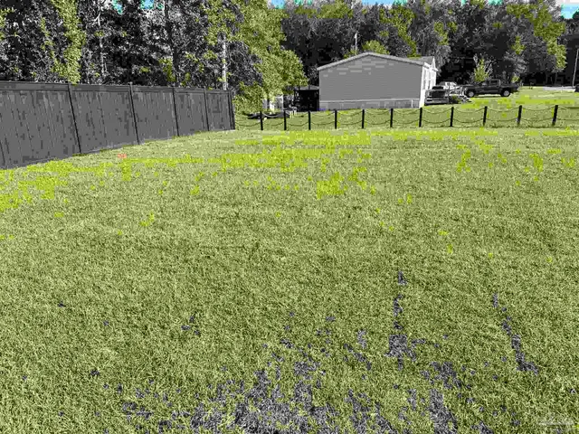 a view of a chair and table in the yard