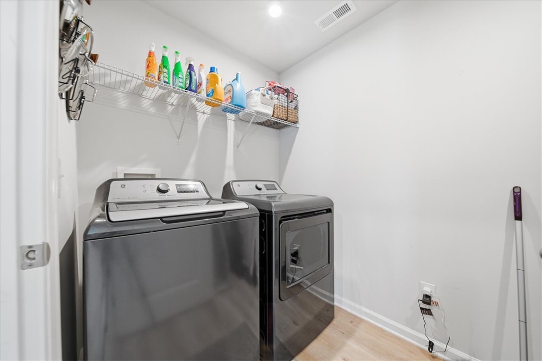 117 Alice Court Easley, SC 29642 - Photo 18 of 26 Functional laundry room equipped with modern appliances and convenient wire shelving for storage.