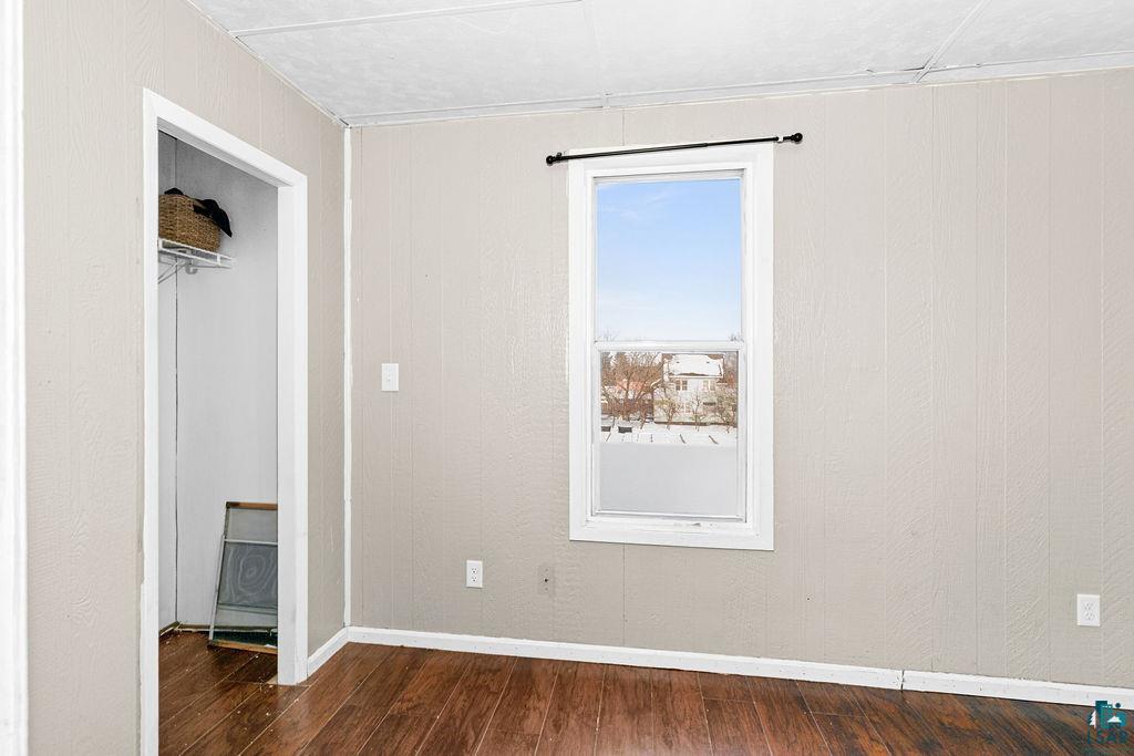 605 Weeks Avenue Superior, WI 54880 - Photo 8 of 21 Unfurnished room featuring dark wood-style floors and baseboards