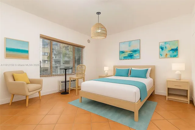 a bedroom with a bed chairs and two windows