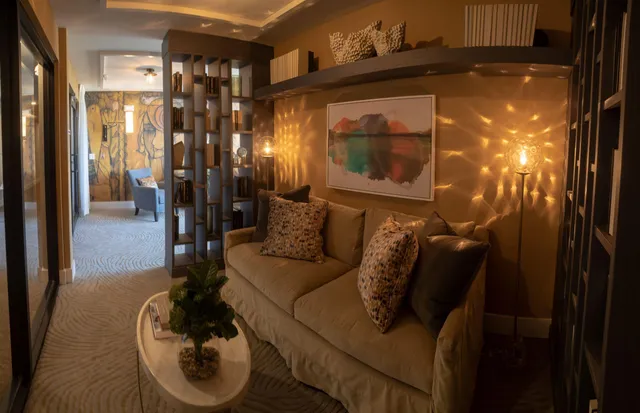 a living room with furniture and a glass door