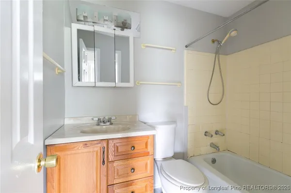 a bathroom with a granite countertop sink a toilet and shower