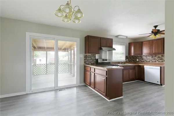 a kitchen with a stove a sink and a refrigerator