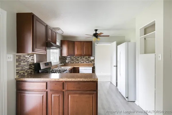 a kitchen with a refrigerator and a sink
