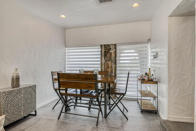 a view of a dining room with furniture and window
