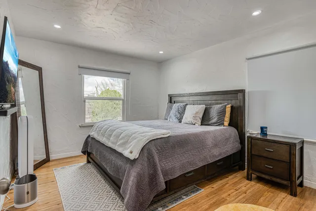 a bedroom with a bed and a mirror