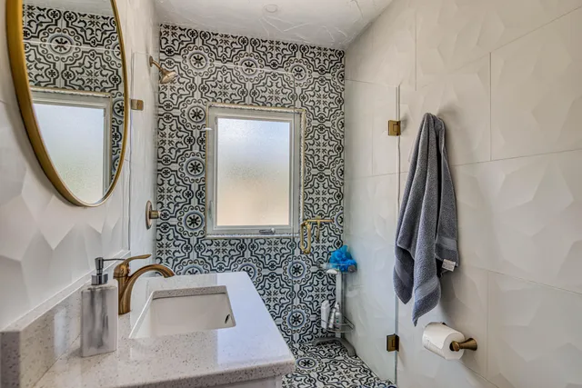 a bathroom with a sink toilet and mirror