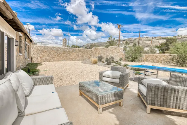 a balcony with furniture and a potted plant