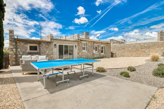 a white bench sitting in front of a house
