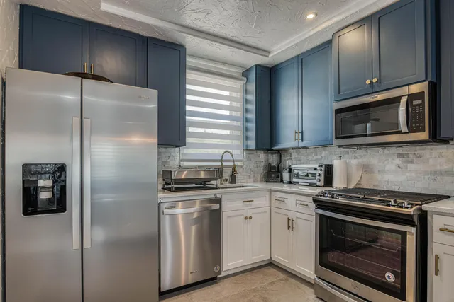 a kitchen with a refrigerator stove and microwave