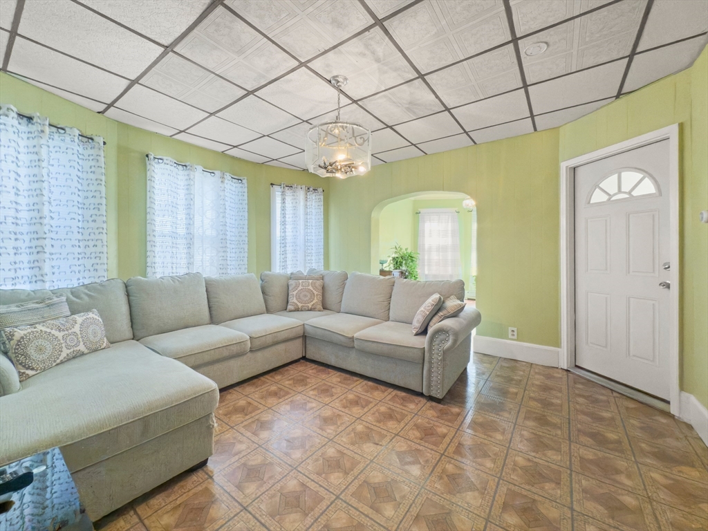 339-341 Lawrence Street Lawrence, MA 01841 - Photo 2 of 20 a living room with furniture and a large window