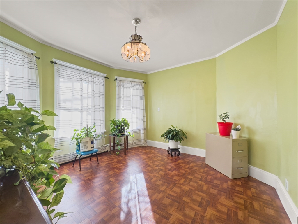 339-341 Lawrence Street Lawrence, MA 01841 - Photo 3 of 20 a room with furniture and a potted plant