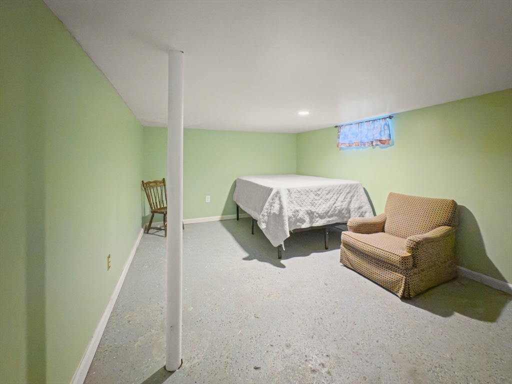339-341 Lawrence Street Lawrence, MA 01841 - Photo 4 of 20 a spacious bedroom with a bed and a couch