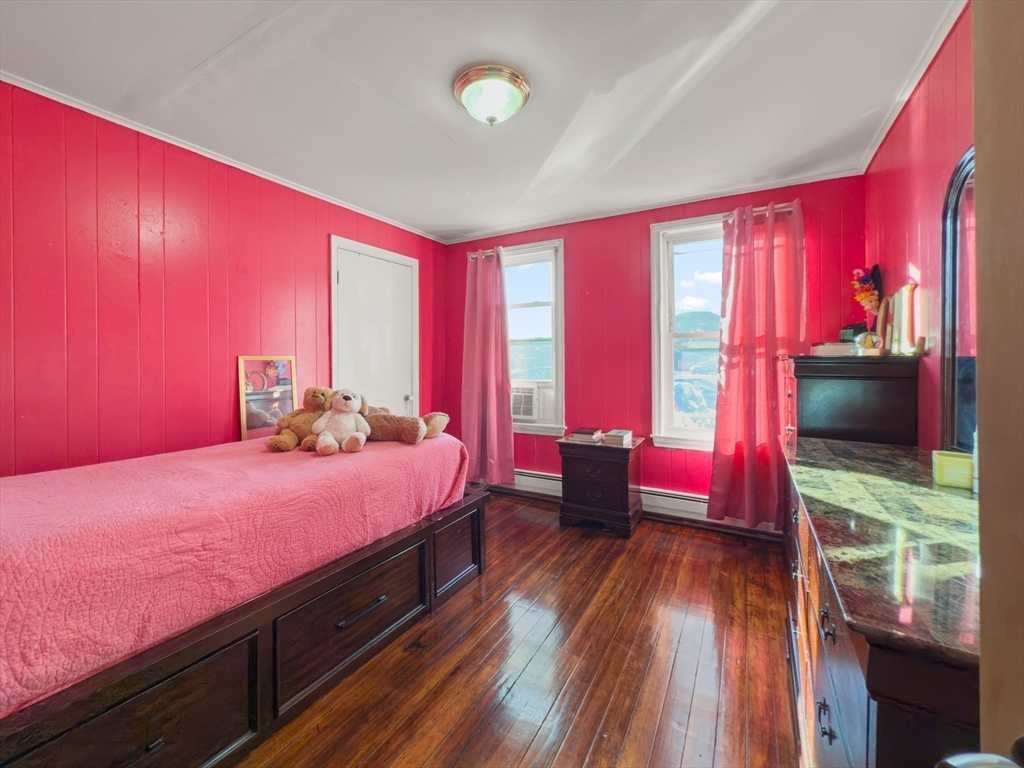 339-341 Lawrence Street Lawrence, MA 01841 - Photo 9 of 20 a bedroom with a bed window and flat screen tv