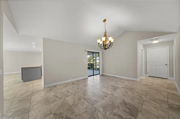 a view of a chandelier in big room and chandelier fan