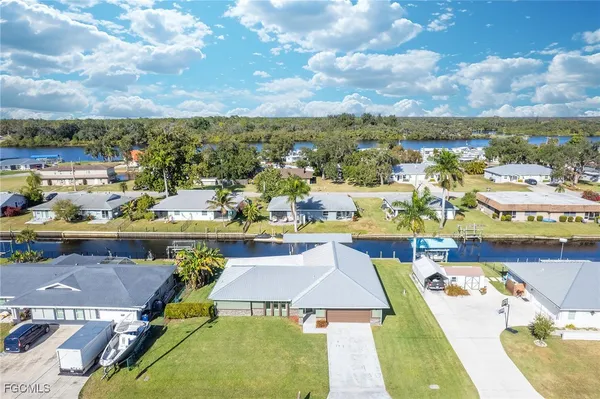 a aerial view of a house with swimming pool garden and patio