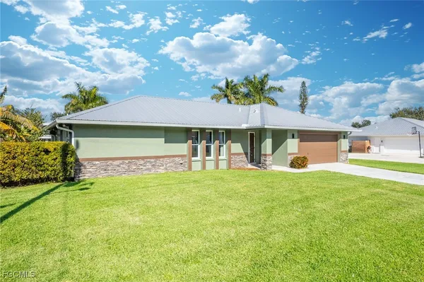 a front view of a house with a yard