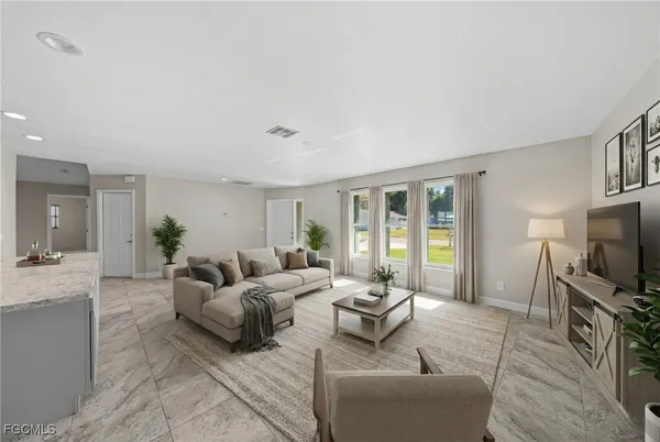 a living room with furniture and a large window