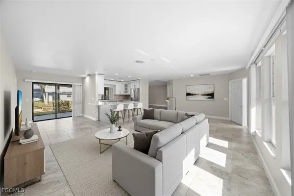 a kitchen with stainless steel appliances granite countertop a sink and a refrigerator
