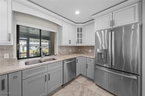 a kitchen with a sink stove and microwave