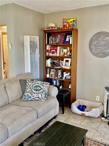a bedroom with furniture and a book shelf