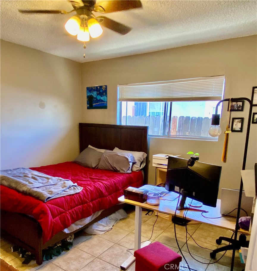 5846 Gardenia Avenue Long Beach, CA 90805 - Photo 21 of 28 a bedroom with a bed and a chandelier