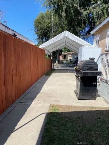 a view of a house with backyard sitting area and tub