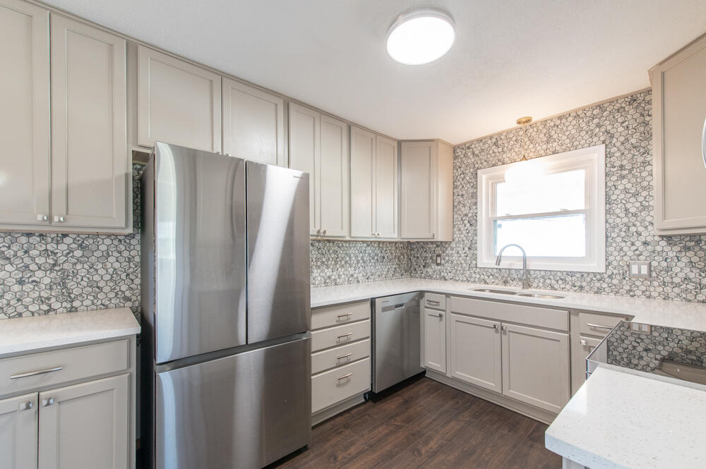 335 Indian Trail Augusta, GA 30907 - Photo 5 of 24 a kitchen with a white refrigerator freezer a sink and dishwasher with wooden floor