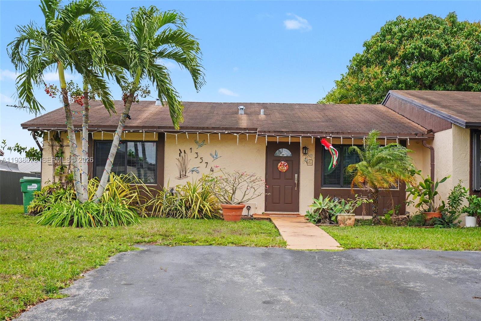 13574 Southwest 49th Lane Miami, FL 33175 - Photo 1 of 36 a front view of house with yard and green space