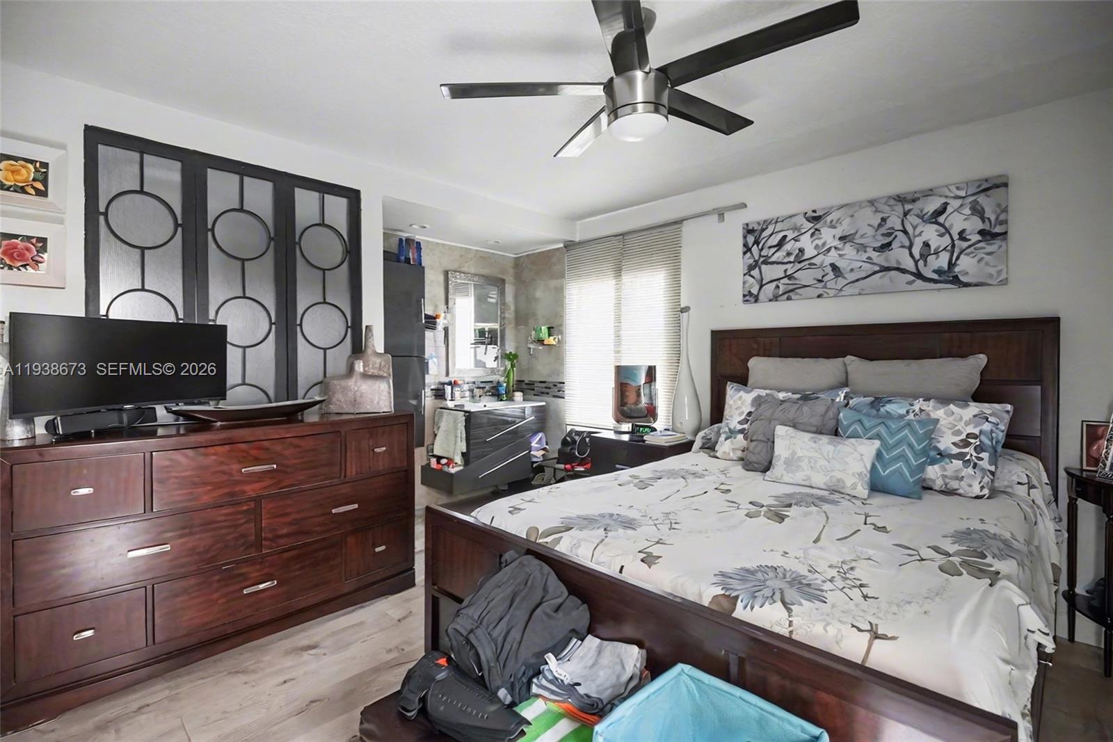 13574 Southwest 49th Lane Miami, FL 33175 - Photo 19 of 36 a bedroom with a bed and a flat screen tv