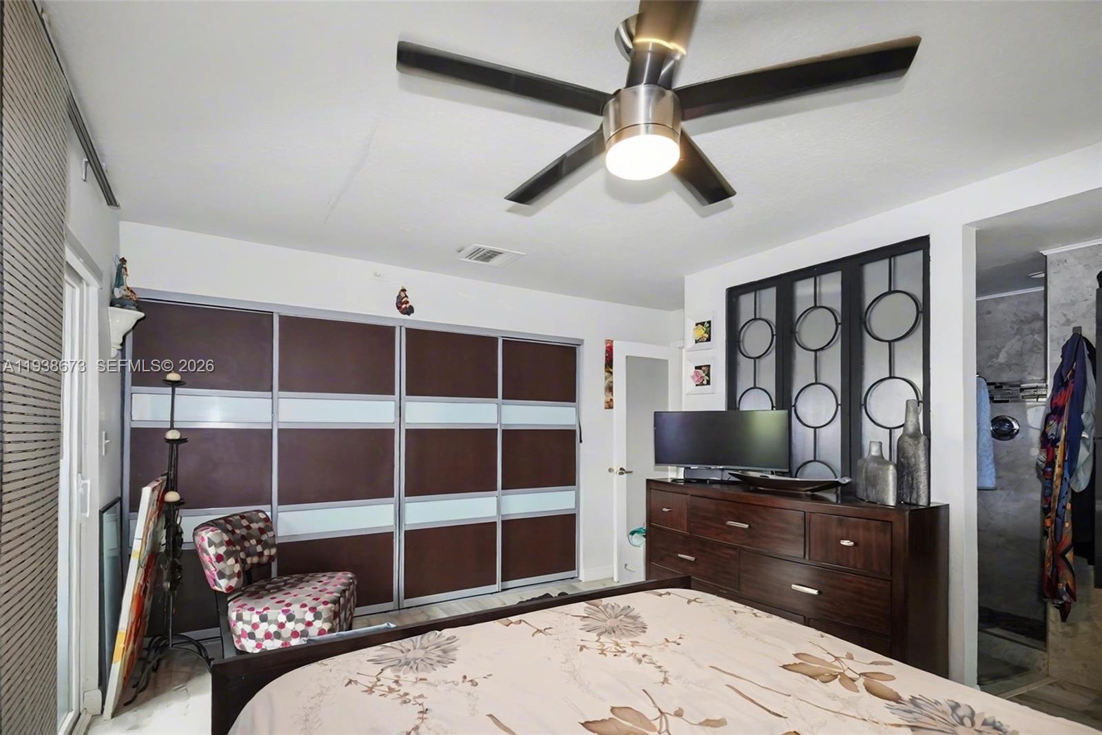 13574 Southwest 49th Lane Miami, FL 33175 - Photo 21 of 36 a bed room with a bed and a television