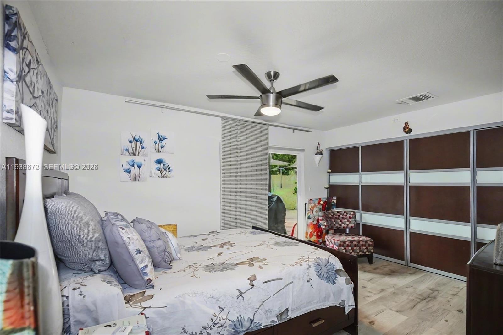 13574 Southwest 49th Lane Miami, FL 33175 - Photo 22 of 36 a bedroom with a large bed and a window