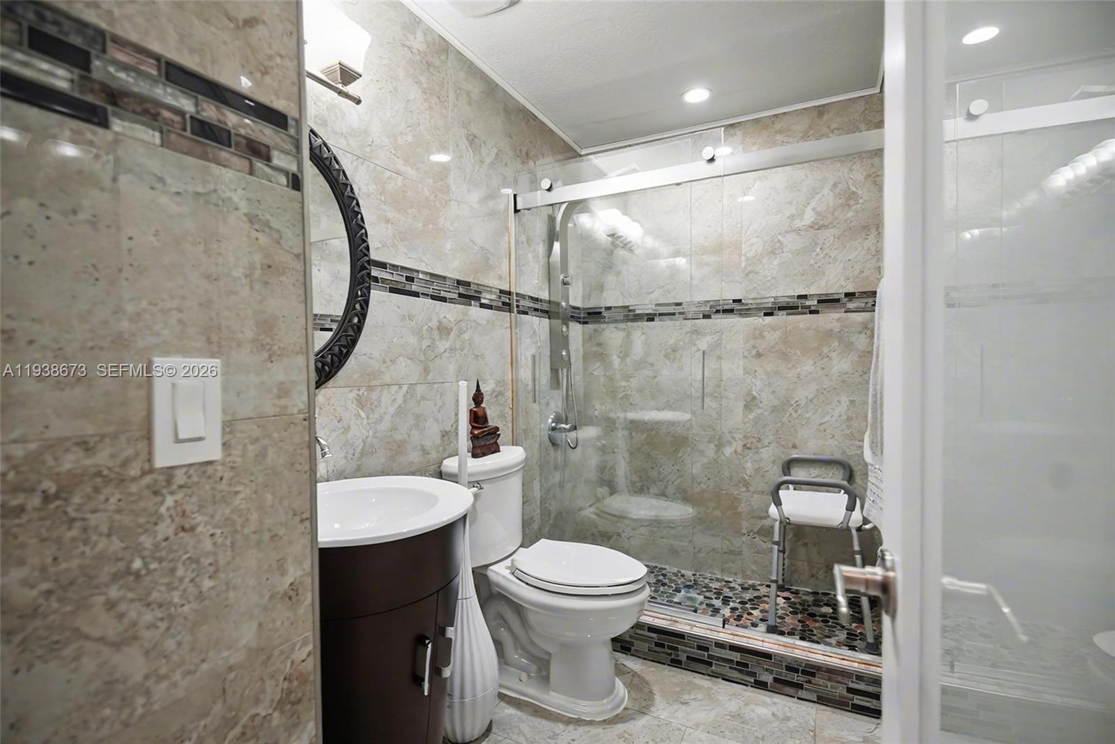 13574 Southwest 49th Lane Miami, FL 33175 - Photo 25 of 36 a bathroom with a toilet a sink and a shower