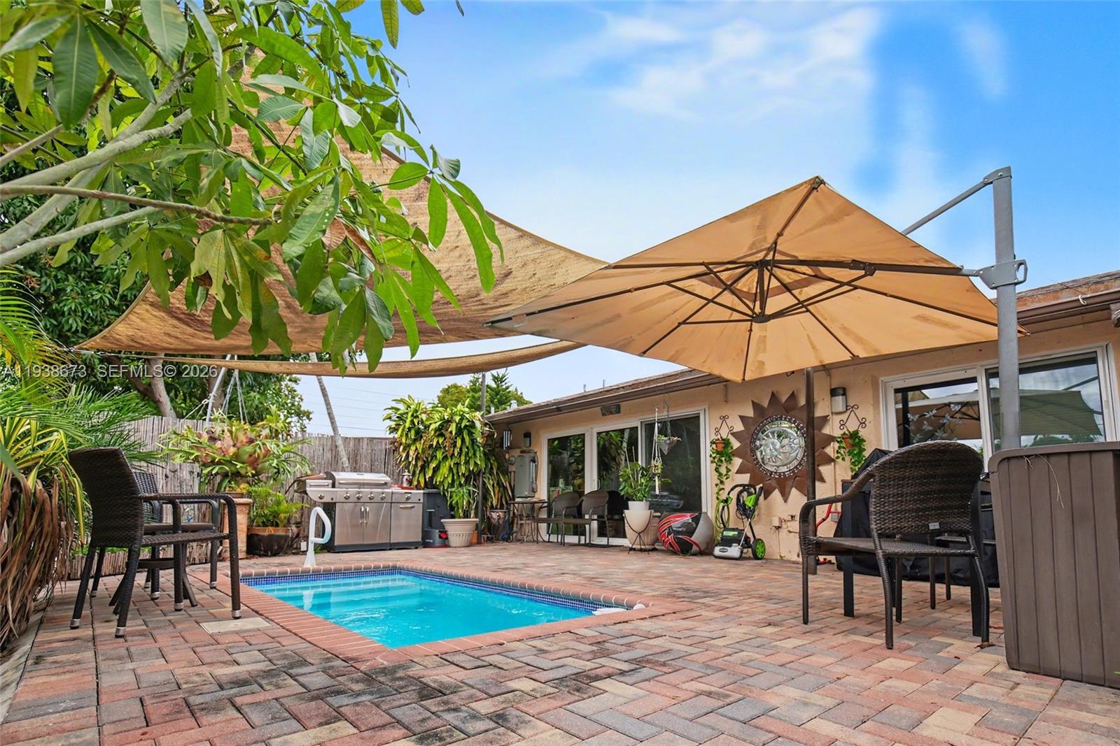 13574 Southwest 49th Lane Miami, FL 33175 - Photo 30 of 36 a view of a chairs and table in backyard of a house
