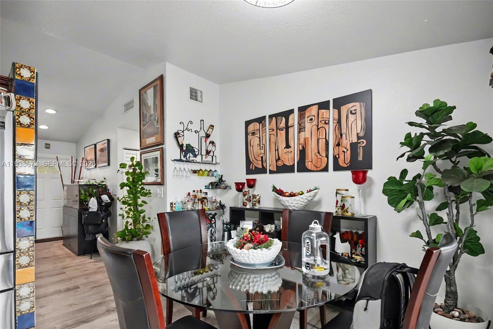 13574 Southwest 49th Lane Miami, FL 33175 - Photo 33 of 36 a dining room with furniture potted plants and wooden floor