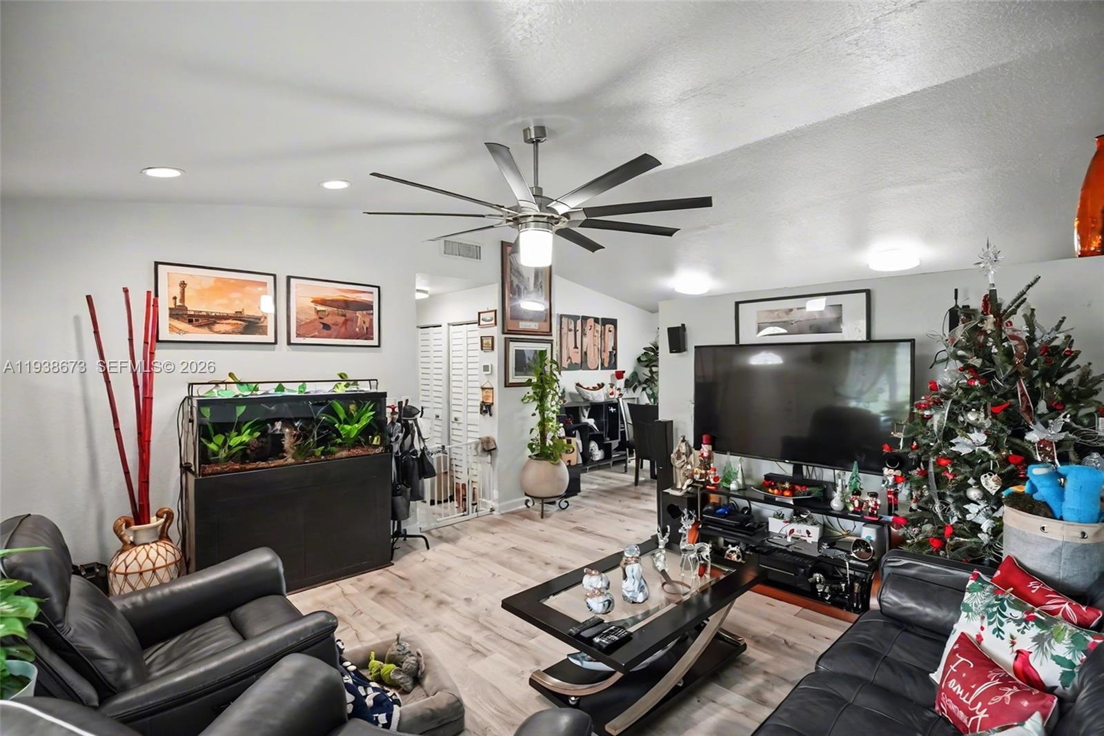 13574 Southwest 49th Lane Miami, FL 33175 - Photo 4 of 36 a living room with furniture and a flat screen tv